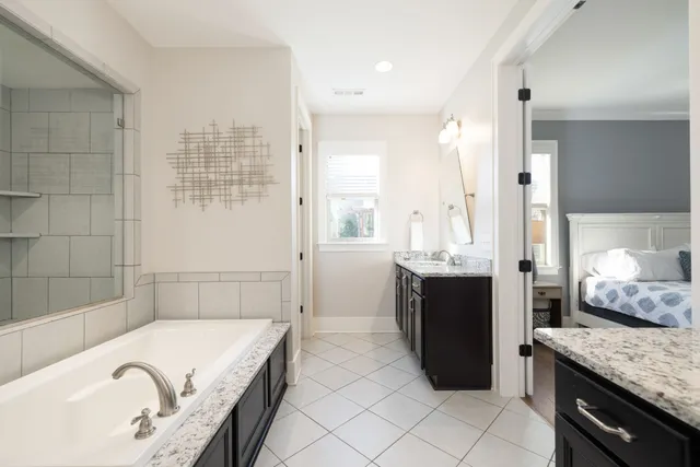 a bathroom with a granite countertop sink a toilet and shower