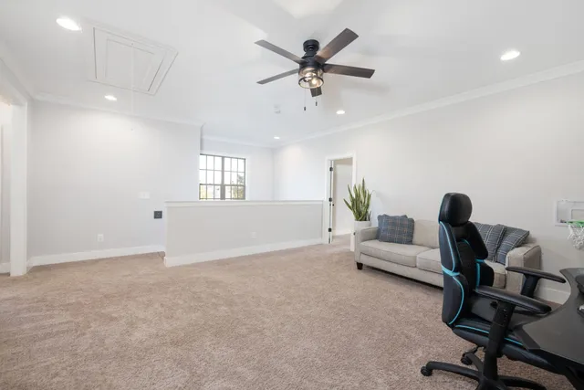 a living room with patio furniture and a floor to ceiling window