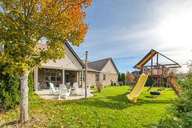 an aerial view of a house with garden space and lake view