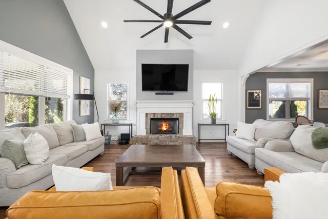 a living room with furniture fireplace and flat screen tv