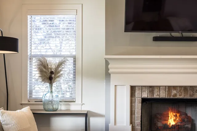 a living room with furniture a flat screen tv and a fireplace