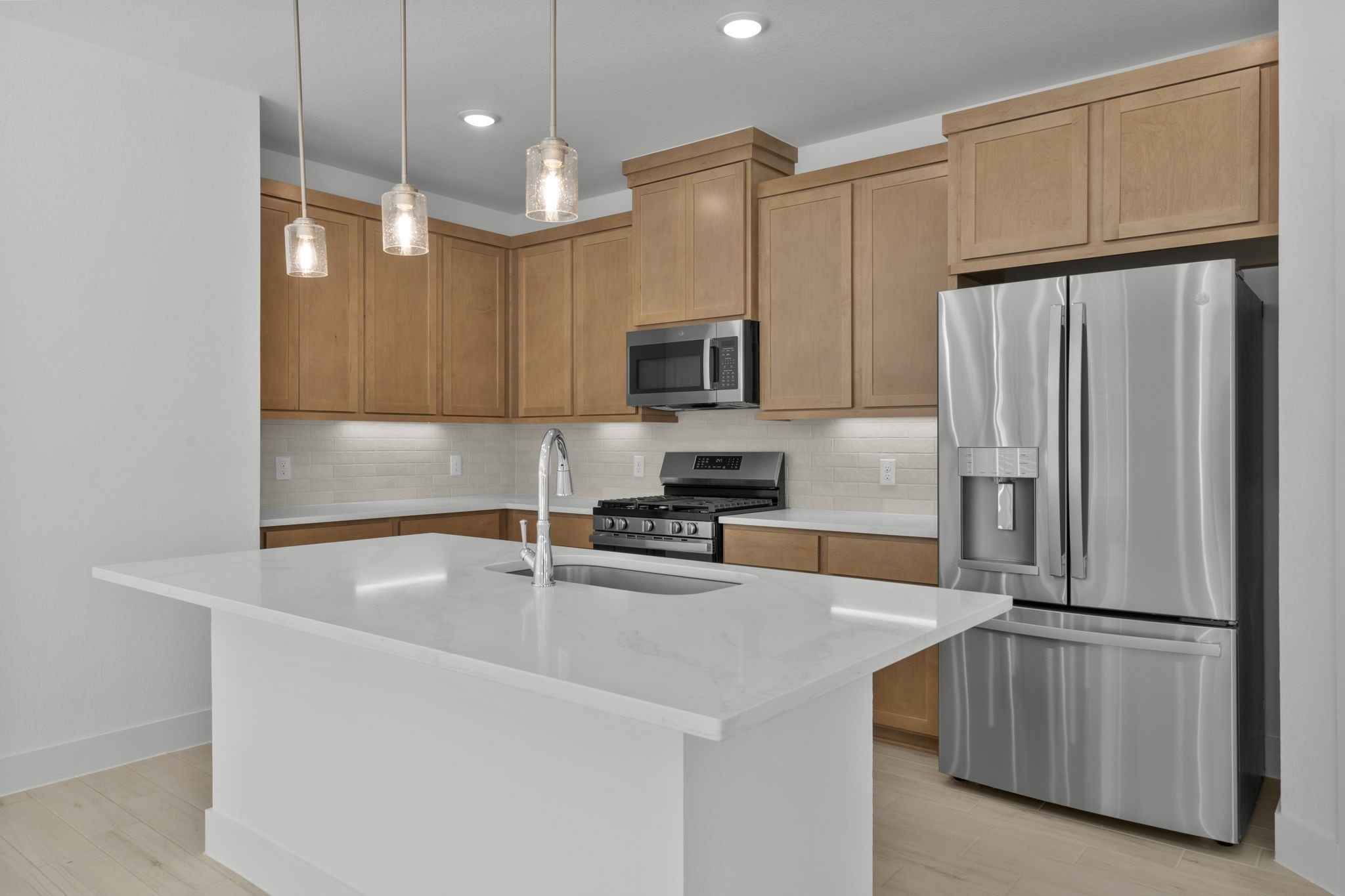 5227 Celestial Court Iowa Colony, TX 77583 - Photo 12 of 43 a kitchen with kitchen island a counter top space stainless steel appliances and cabinets