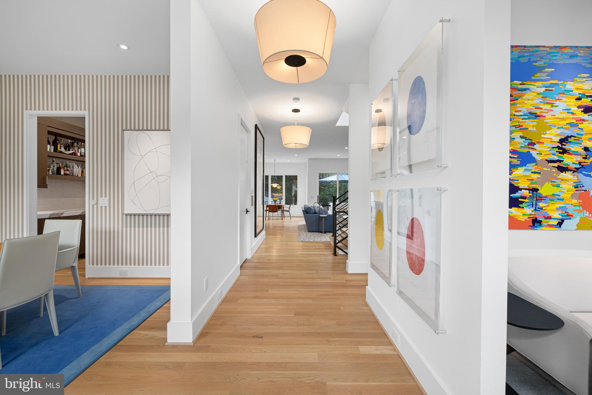 5624 Sherier Place Northwest Washington, DC 20016 - Photo 3 of 60 a view of a hallway with wooden floor windows and a chandelier