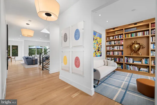 a large kitchen with kitchen island a dining table chairs and a wooden floor