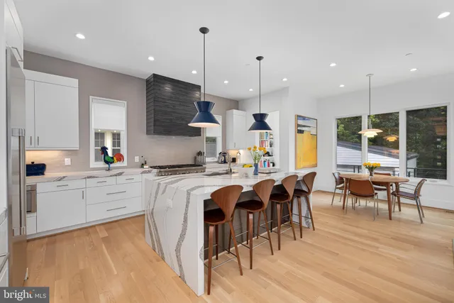 a kitchen with stainless steel appliances granite countertop a stove and a wooden floors