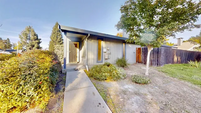 a front view of a house with garden