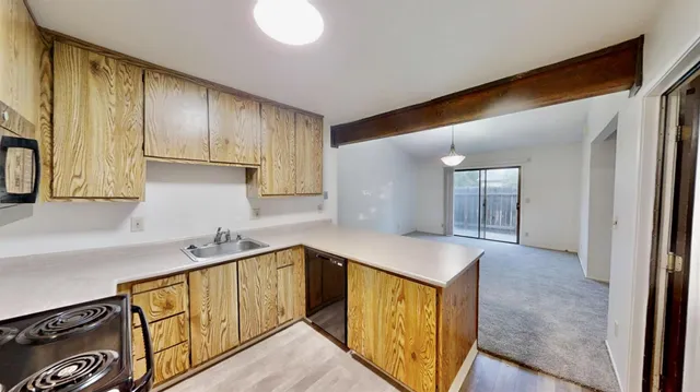 a kitchen with stainless steel appliances granite countertop a sink stove and cabinets