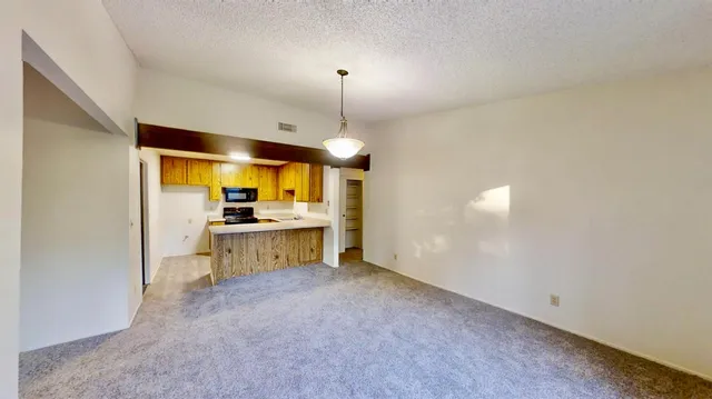 a view of a kitchen with a sink and cabinets