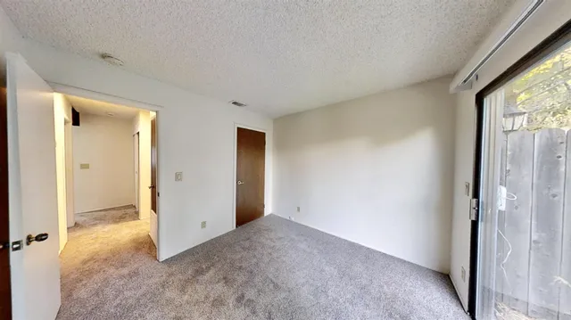 a view of an empty room and a window