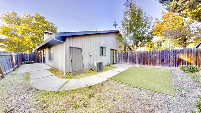 a backyard of a house with a yard and outdoor seating