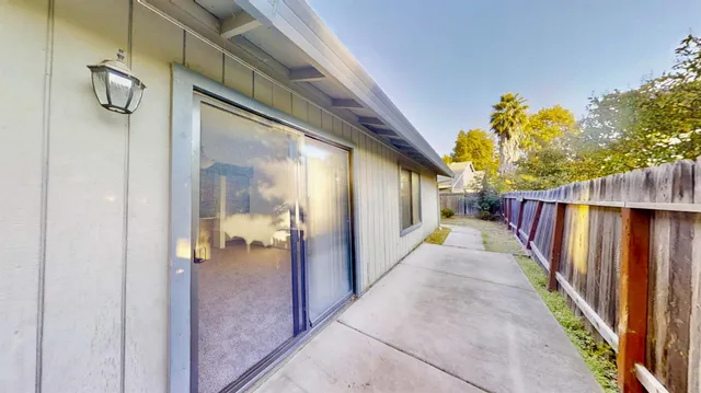 a view of a refrigerator with wooden cabinets