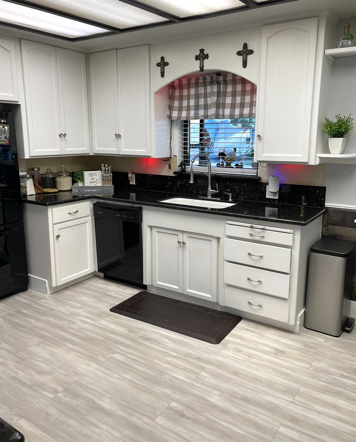 2313 Thomas Street Ceres, CA 95307 - Photo 12 of 35 a kitchen with granite countertop a stove a sink and a microwave