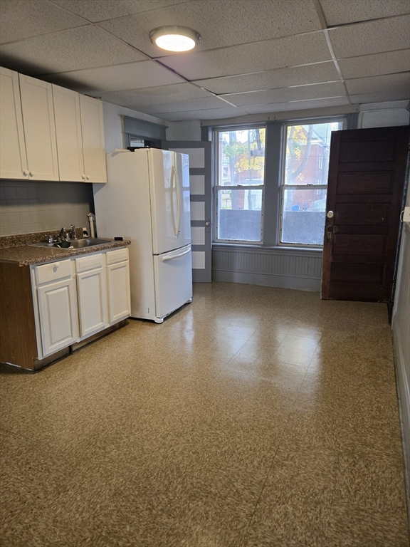 37 Clinton Avenue, Unit 3R Holyoke, MA 01040 - Photo 2 of 8 a kitchen with a refrigerator a stove and a window