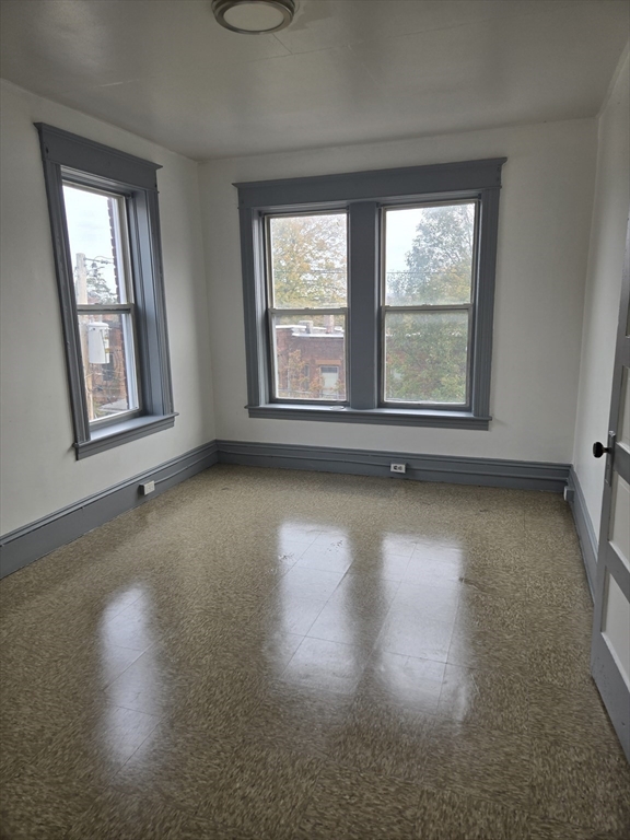 37 Clinton Avenue, Unit 3R Holyoke, MA 01040 - Photo 5 of 8 an empty room with wooden floor and windows