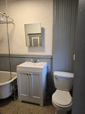 a bathroom with a toilet a sink and bathtub