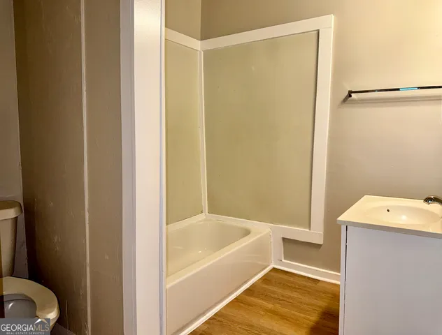 a bathroom with a tub and shower