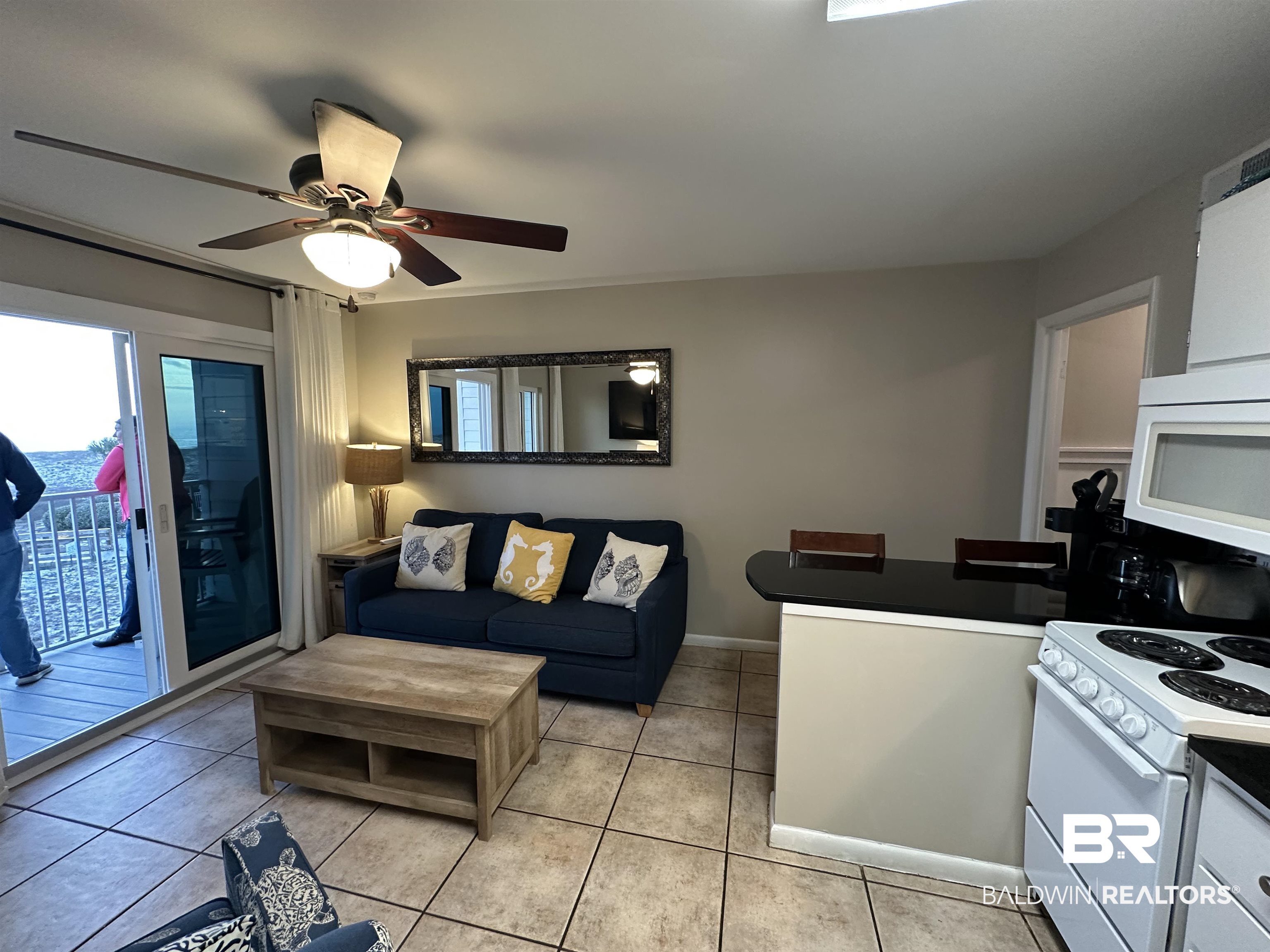 400 Plantation Road, Unit 2202 Gulf Shores, AL 36542 - Photo 26 of 26 Kitchen featuring white appliances, dark countertops, light tile patterned flooring, and ceiling fan