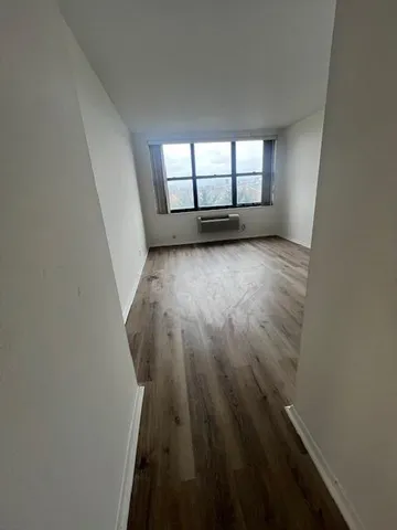 a view of a room with wooden floor