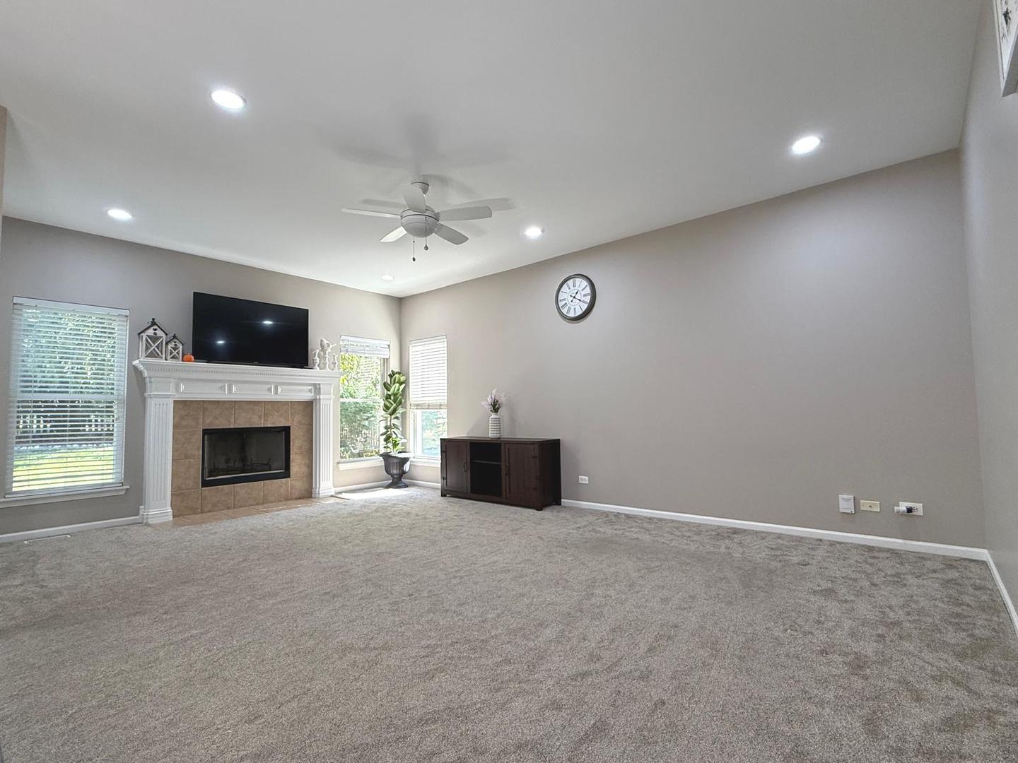 731 Lake Ridge Drive South Elgin, IL 60177 - Photo 8 of 28 an empty room with fireplace and windows