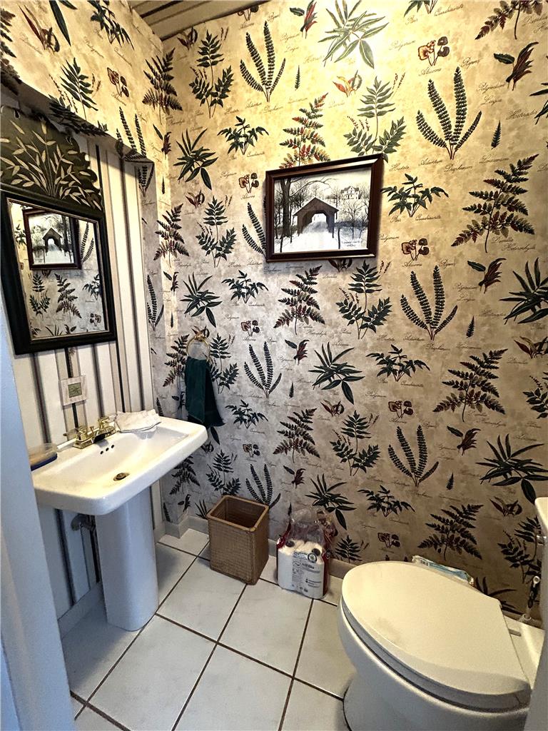 1214 Stanford Road Bethlehem, PA 18018 - Photo 34 of 58 Tiled flooring complements a pedestal sink in this compact, well-appointed bathroom.