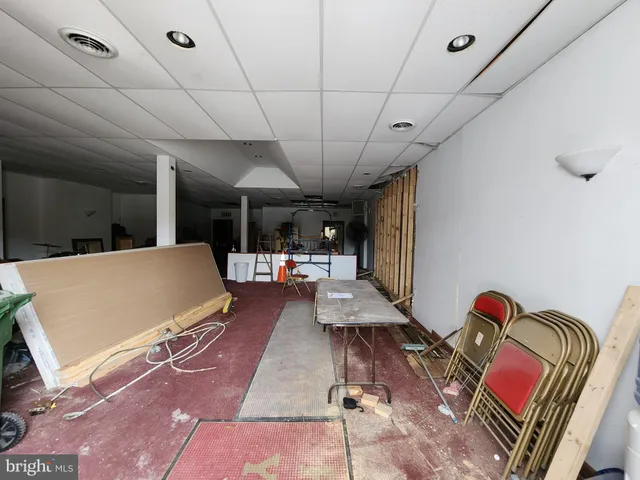 a living room with furniture gym equipment and a rug