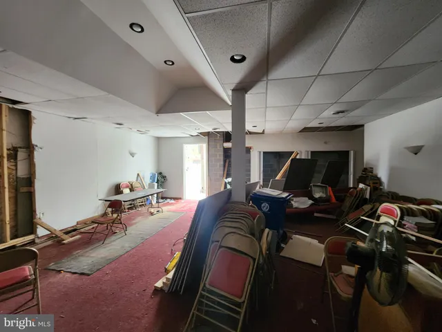 a room with furniture a flat screen tv and a desk