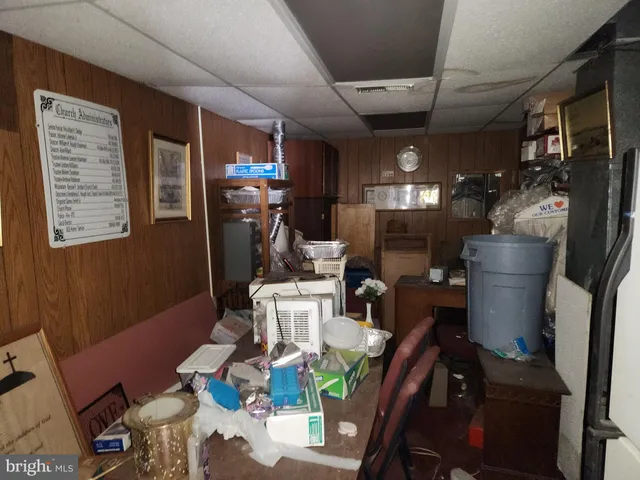 a view of a dining room with furniture a kitchen and chandelier
