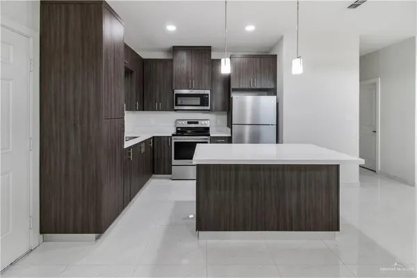 a kitchen with stainless steel appliances a refrigerator and a sink