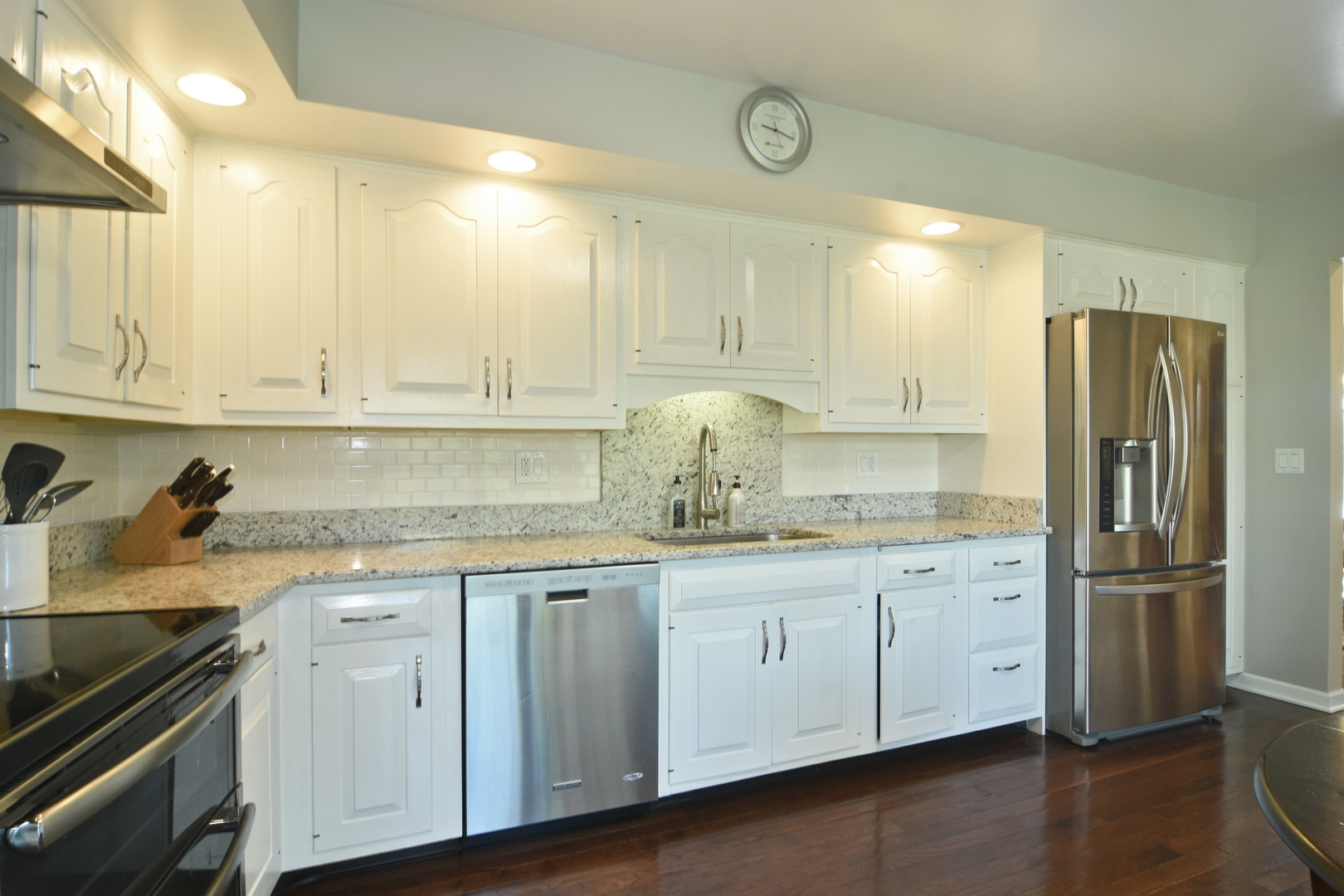2305 Greenwood Road Northbrook, IL 60062 - Photo 12 of 25 a kitchen with granite countertop white cabinets white appliances and sink