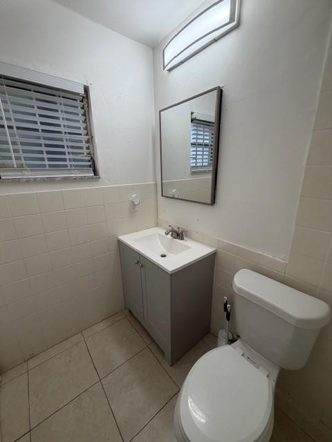 4654 Schall Road, Unit 4654 West Palm Beach, FL 33417 - Photo 10 of 11 a white toilet sitting next to a bathroom sink
