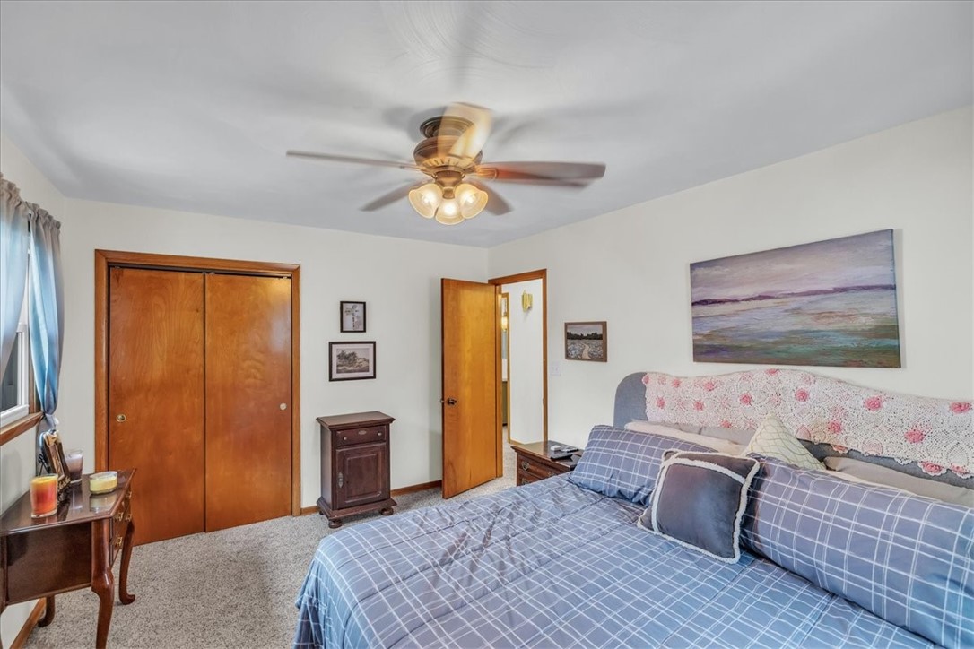 2220 West Ravina Park Road Decatur, IL 62526 - Photo 16 of 36 a bedroom with a bed and a chandelier