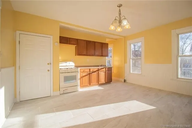 a big room with windows and chandelier