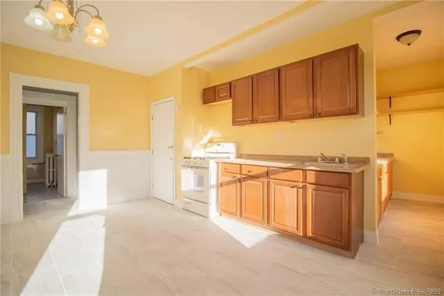 a kitchen with stainless steel appliances granite countertop a sink and cabinets