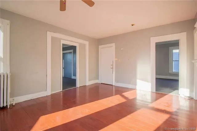 a view of a bedroom with wooden floor