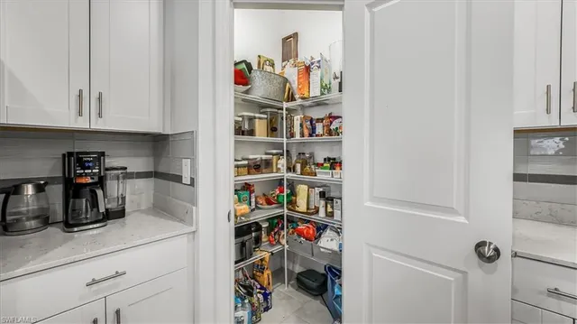 a kitchen with a refrigerator and cabinets