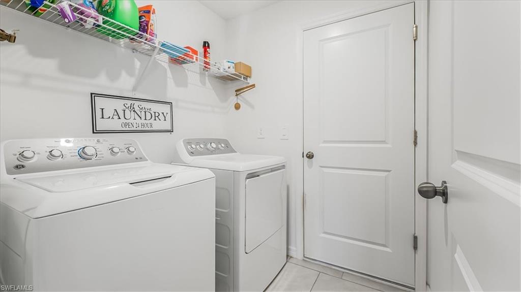 12252 Amber Waves Road Lehigh Acres, FL 33936 - Photo 14 of 35 a view of a storage room with washer and dryer