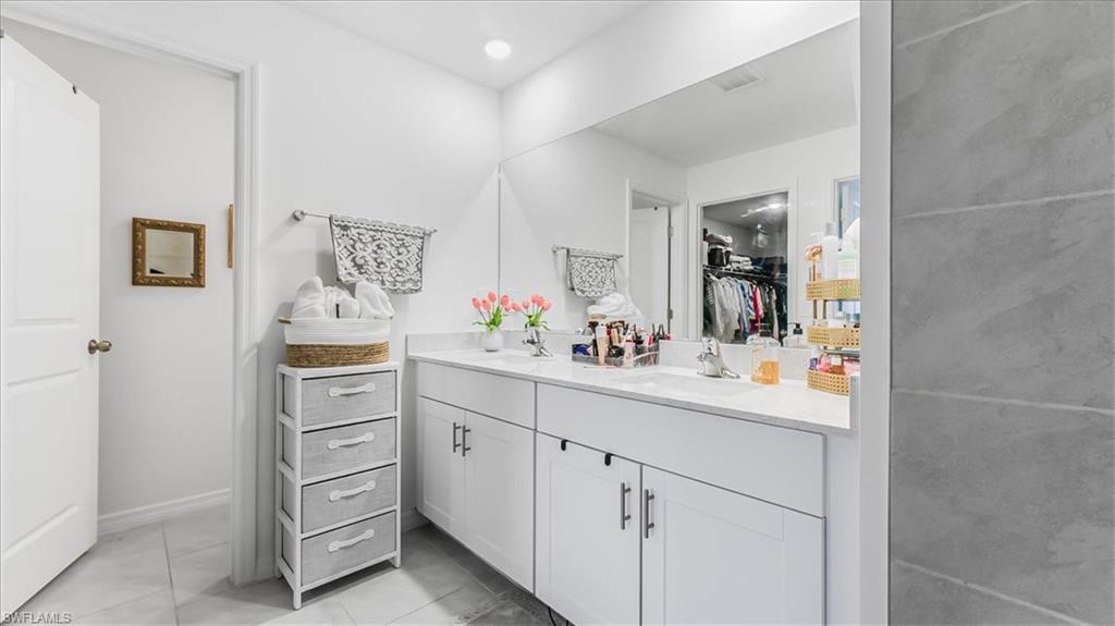 12252 Amber Waves Road Lehigh Acres, FL 33936 - Photo 18 of 35 a kitchen with cabinets and window