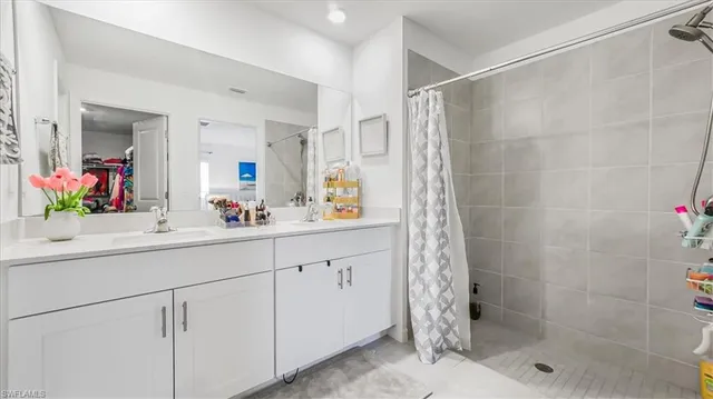 a bathroom with a shower sink and mirror