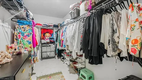 a view of walk in closet with clothes