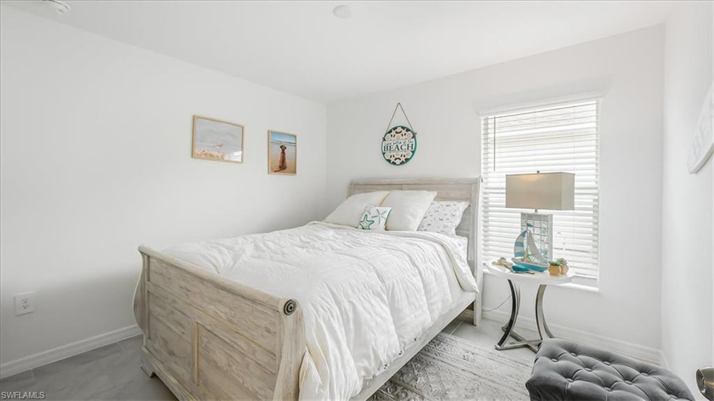 12252 Amber Waves Road Lehigh Acres, FL 33936 - Photo 21 of 35 a bedroom with a bed and a window