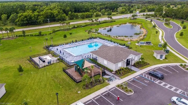 an aerial view of a house with a swimming pool yard and outdoor seating