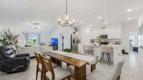 a view of a dining room with furniture and a chandelier