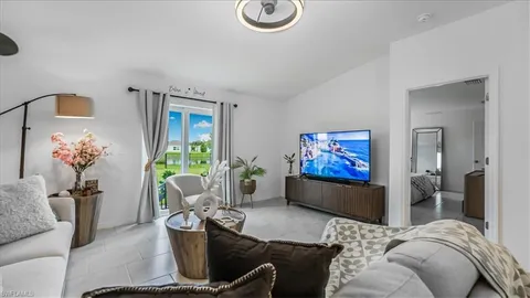 a living room with furniture flowerpot and window
