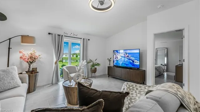 a living room with furniture flowerpot and window