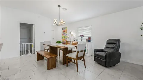 a dining room with furniture and window