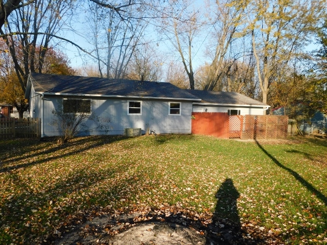 306 Errett Road Rochelle, IL 61068 - Photo 14 of 15 a backyard of a house with yard and outdoor seating