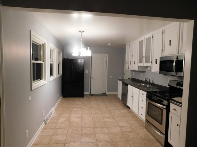 306 Errett Road Rochelle, IL 61068 - Photo 3 of 15 a kitchen with stainless steel appliances a refrigerator a stove a microwave and cabinets