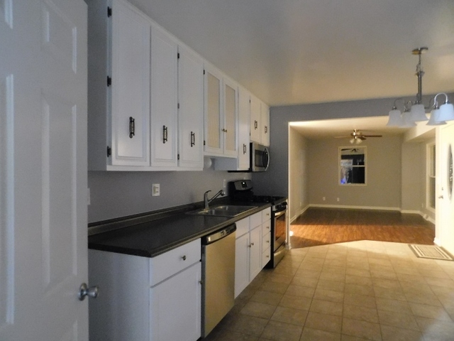 306 Errett Road Rochelle, IL 61068 - Photo 4 of 15 a kitchen with granite countertop a sink and cabinets