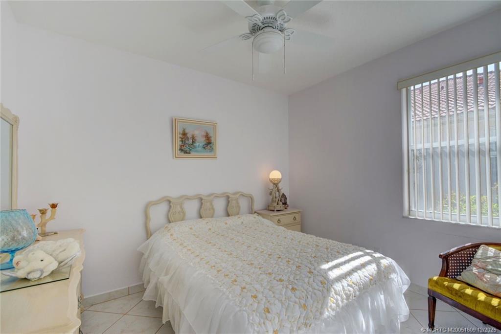 6789 Southeast Warwick Lane Stuart, FL 34997 - Photo 15 of 24 a bedroom with a bed and window