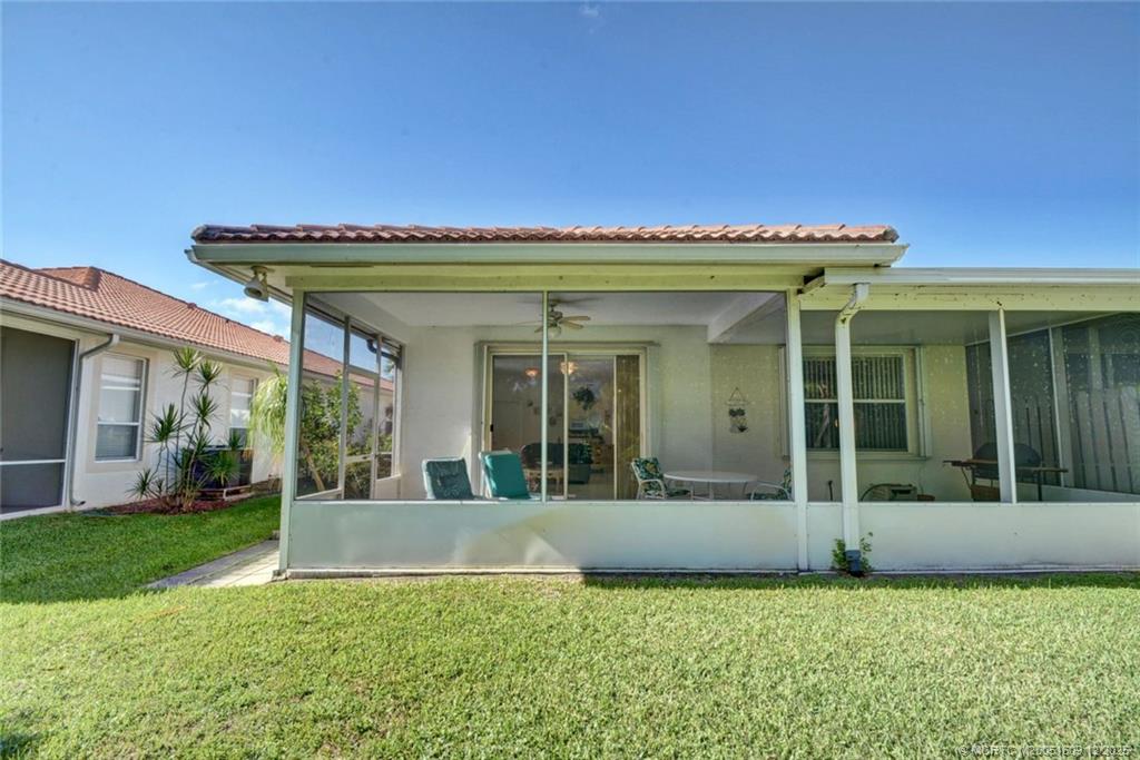 6789 Southeast Warwick Lane Stuart, FL 34997 - Photo 19 of 24 a view of a house with a garden
